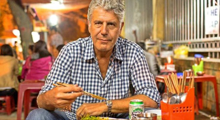 Anthony Bourdain eating at a street-side stall in Hanoi