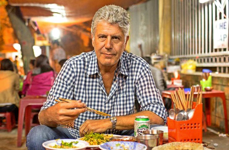 Anthony Bourdain eating at a street-side stall in Hanoi